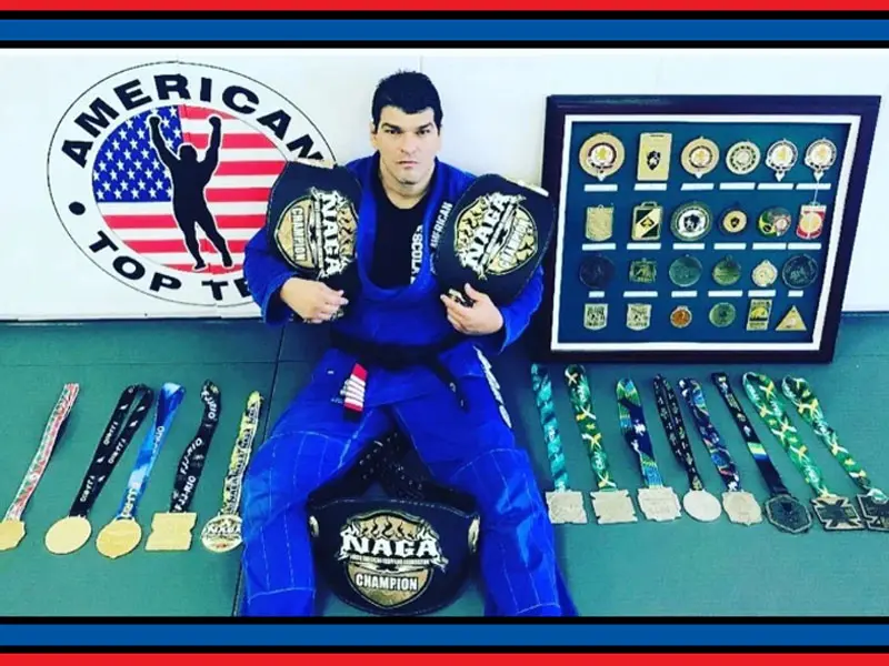 Coach Marcel Ferreira with his championship belts and Brazilian Jiu-Jitsu tournament medals at American Top Team Winter Garden
