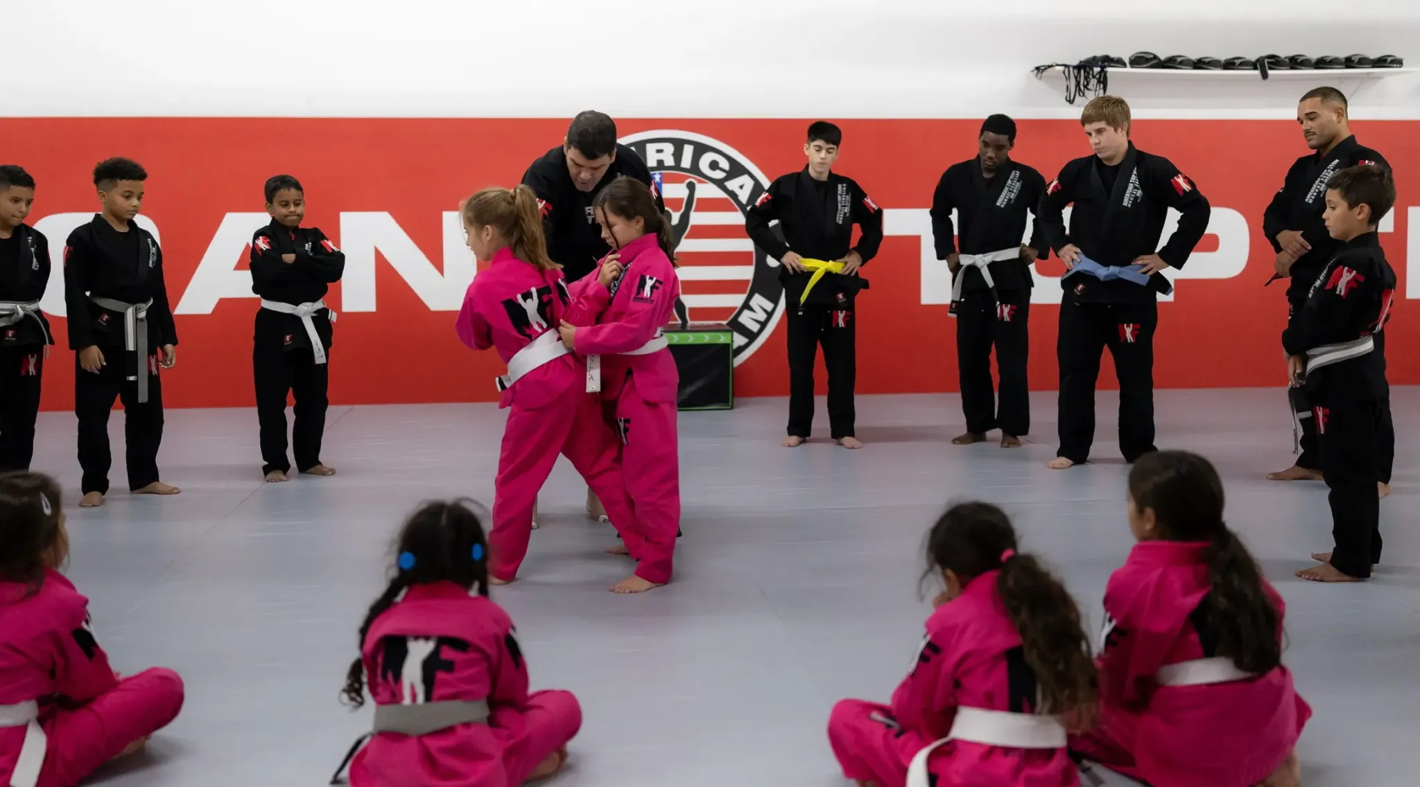 Two girls in gis drilling Brazilian Jiu-Jitsu at ATT Winter Garden