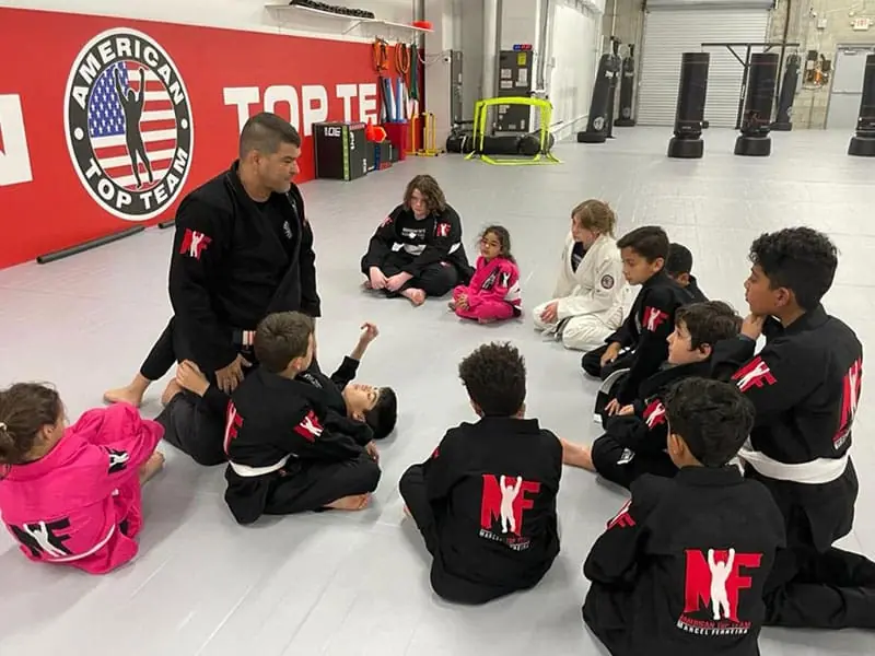 Boys and girls in gis learning Brazilian Jiu-Jitsu together at ATT Winter Garden