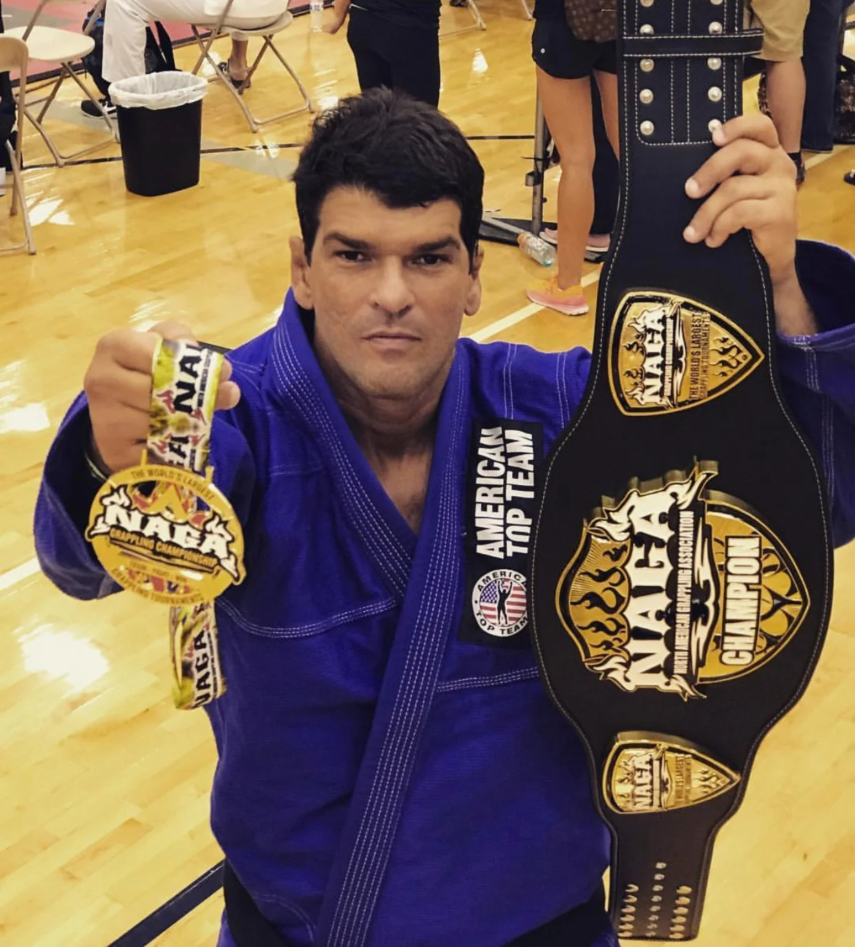 Coach Marcel Ferreira with his championship belt and tournament medals